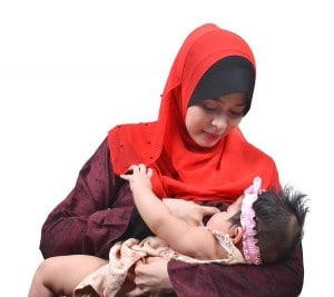 Woman in headscarf breastfeeding baby in pink headband