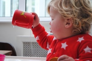 toddler emptying sippy cup