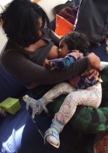 Mother breastfeeding a toddler