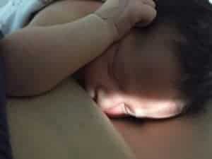Newborn resting on mother's breast. Skin to skin.