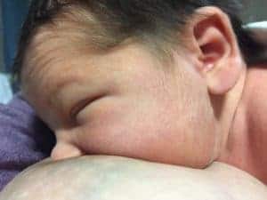 Skin to skin newborn, close-up of breastfeeding showing good latch