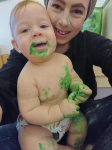Mother and baby covered in green paint